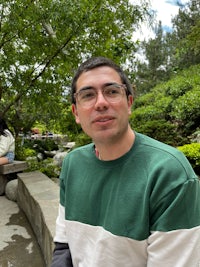 a man wearing a green and white sweater
